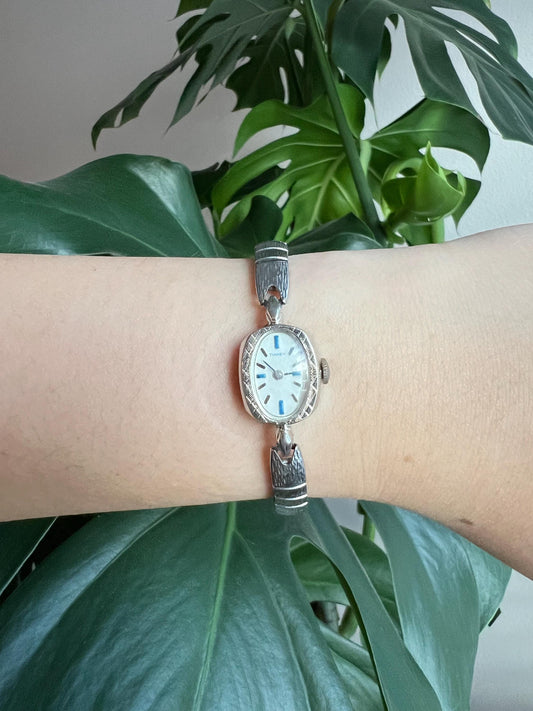 Vintage Timex Dainty Women’s Watch | Oval White Dial | Light Blue Details | Mechanical Hand-Wind | Silver Tone | Stretchy Band